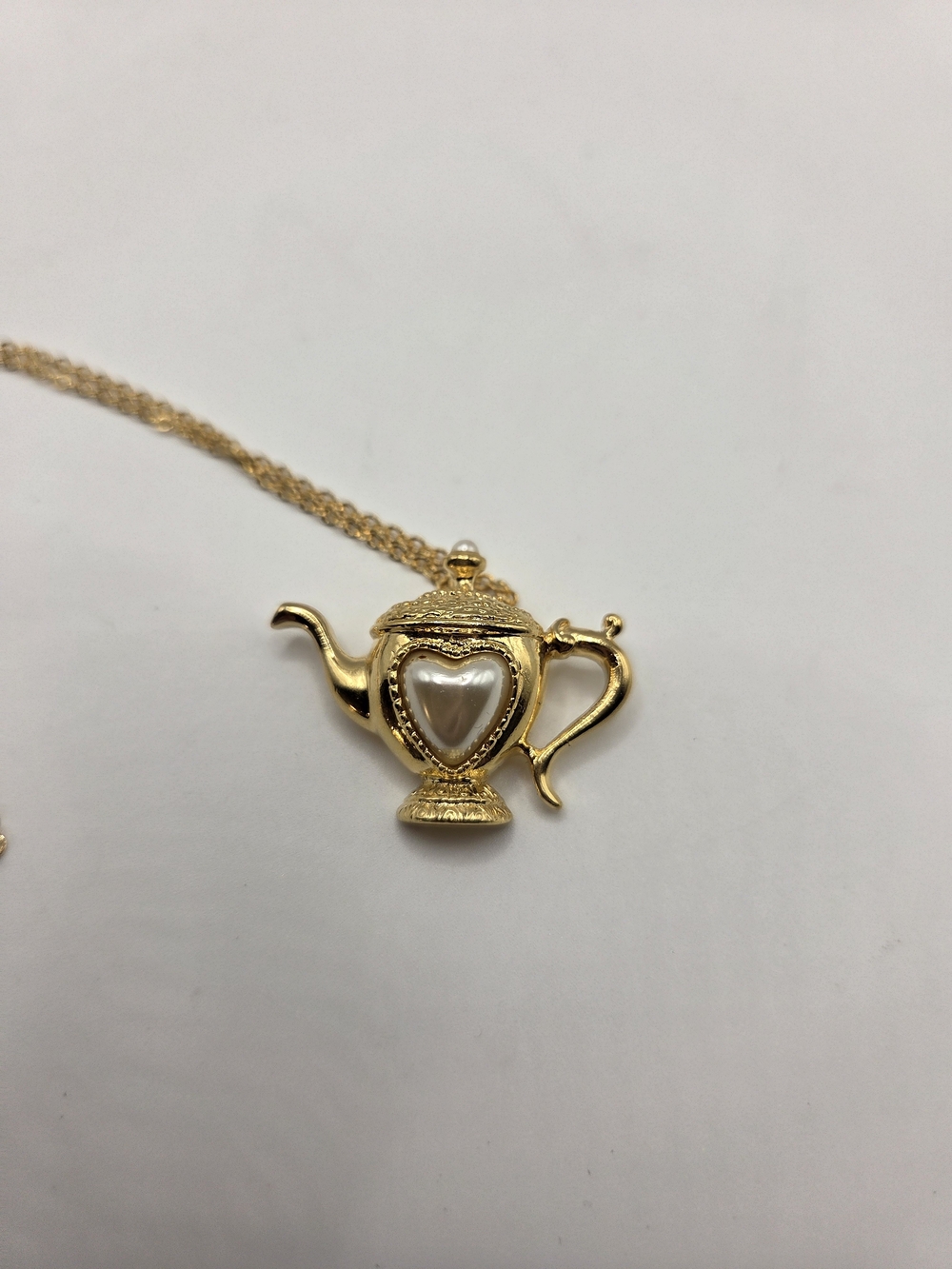 1667. Gold Tone Teapot Pendant Necklace with Pearl Heart Accent
